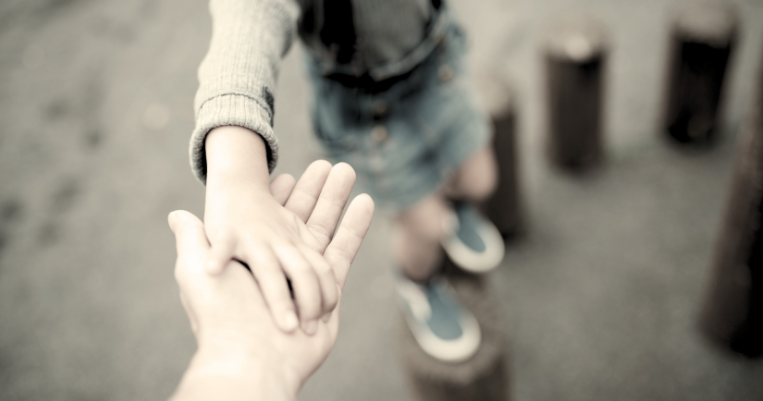 Child holding parent's hand